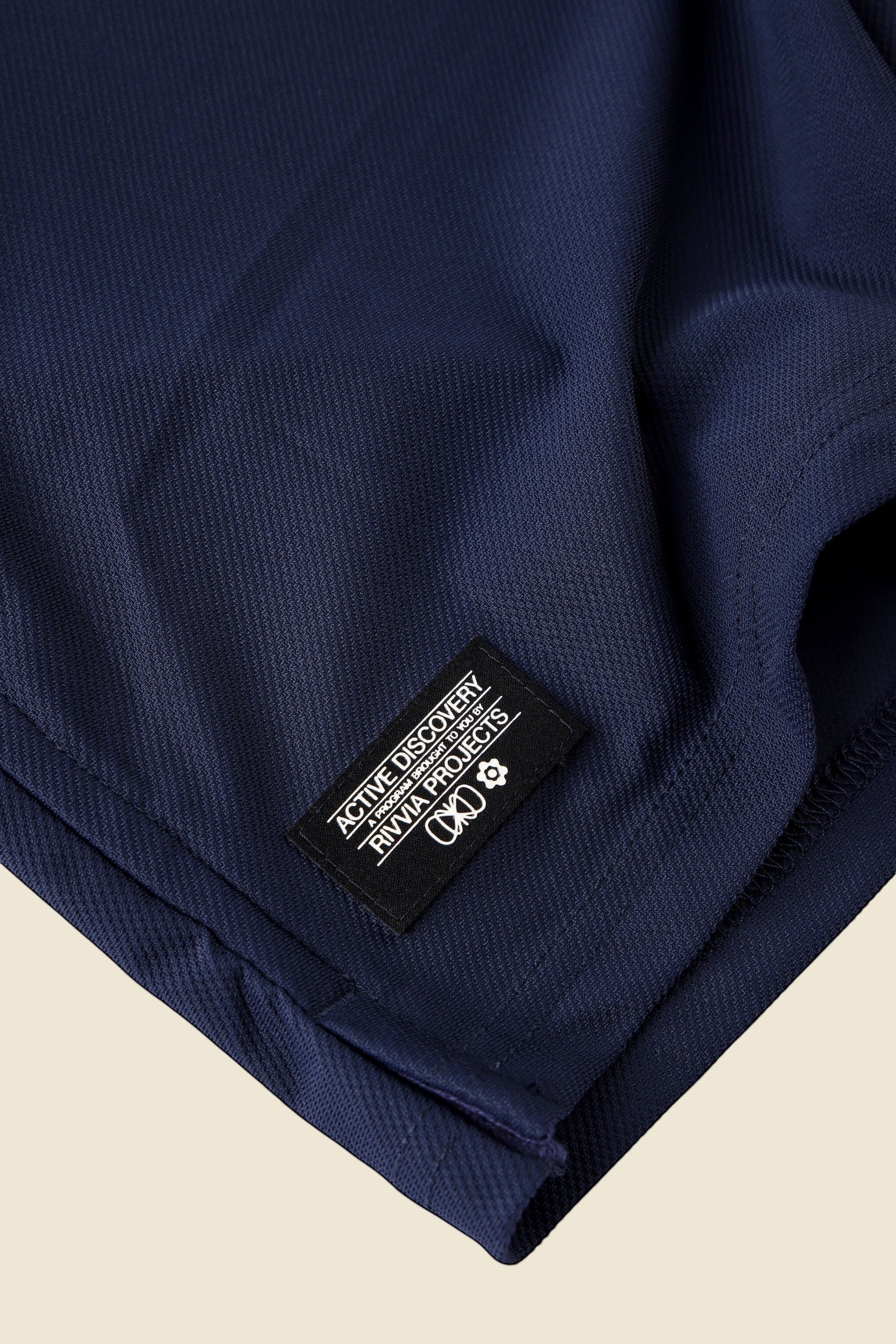 Keel Surf & Supply navy blue polo shirt with black collar and embroidered logo detail.