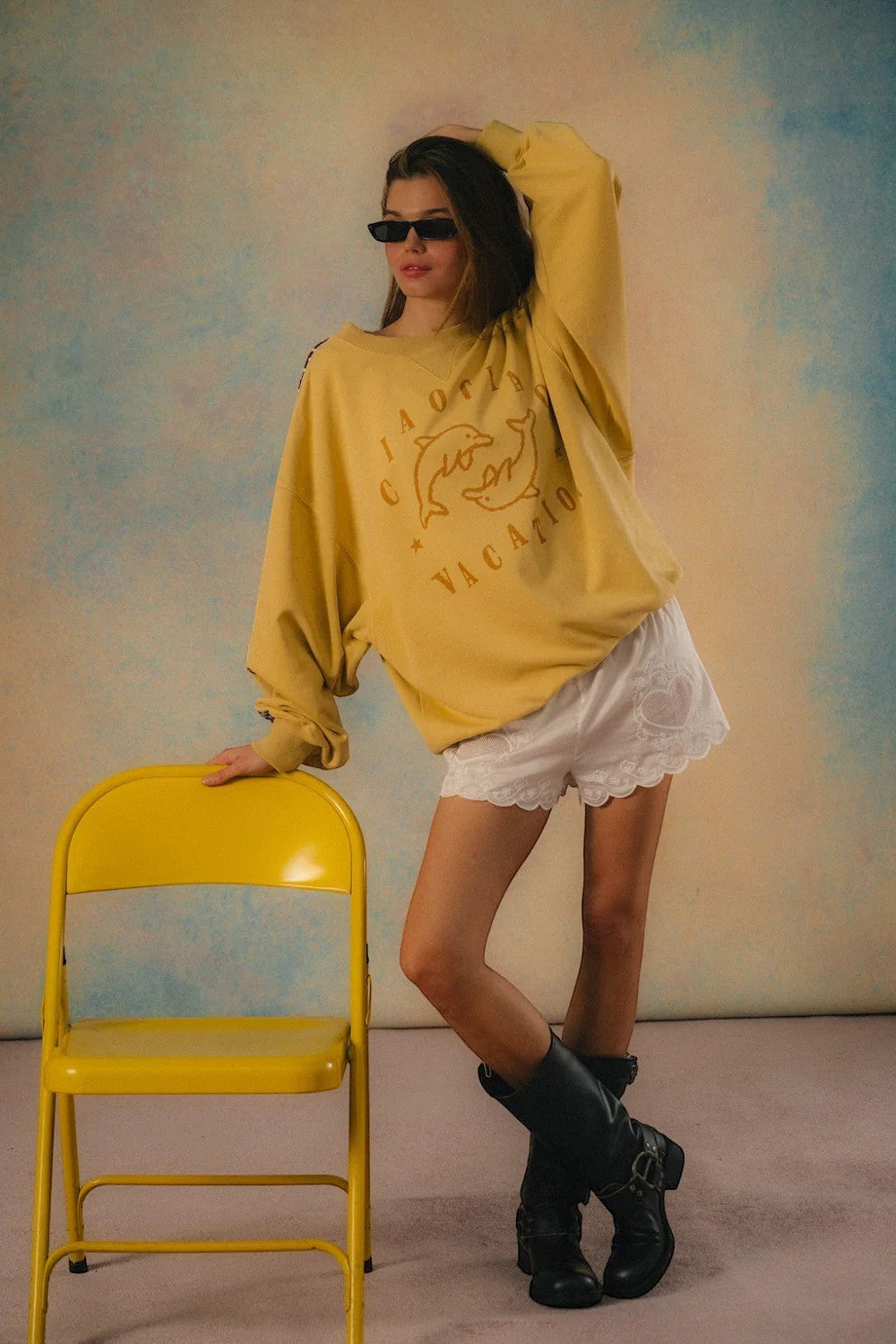 Keel Surf & Supply yellow dolphin graphic Delfino sweater with white lace shorts and black boots