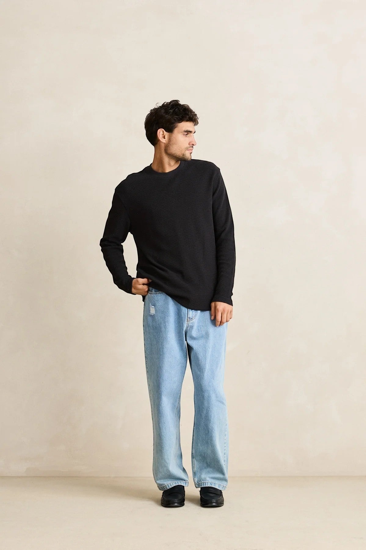 Keel Surf & Supply men's black waffle knit long sleeve shirt with crew neck, paired with light wash distressed jeans.