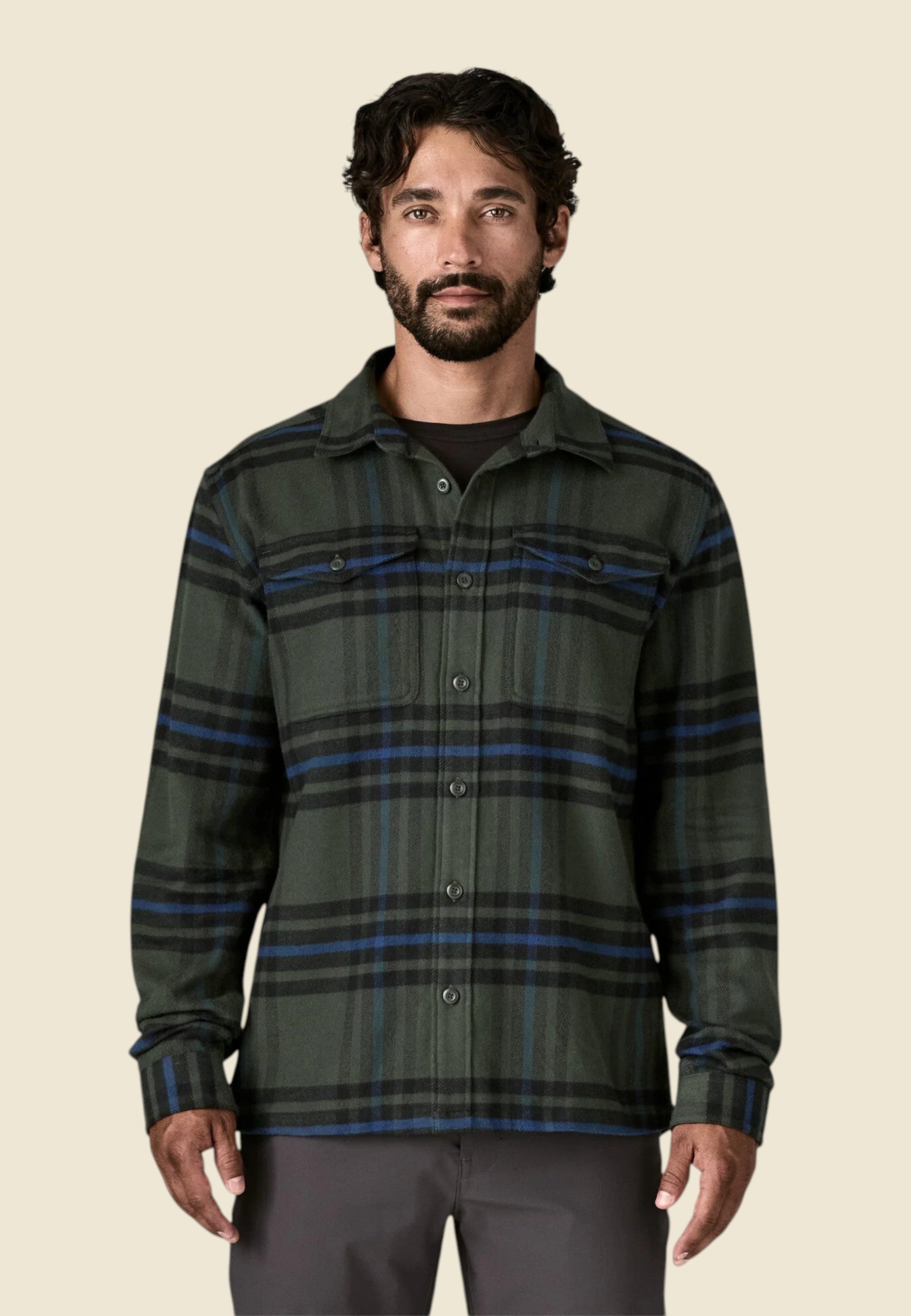 Keel Surf & Supply Men's green, black, and blue plaid organic cotton flannel shirt with two chest pockets and shirttail hem.