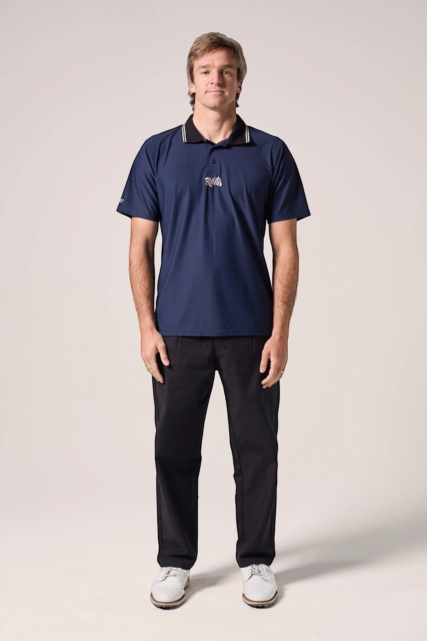 Keel Surf & Supply navy polo shirt with black collar featuring white and gold stripes, embroidered logo on chest.