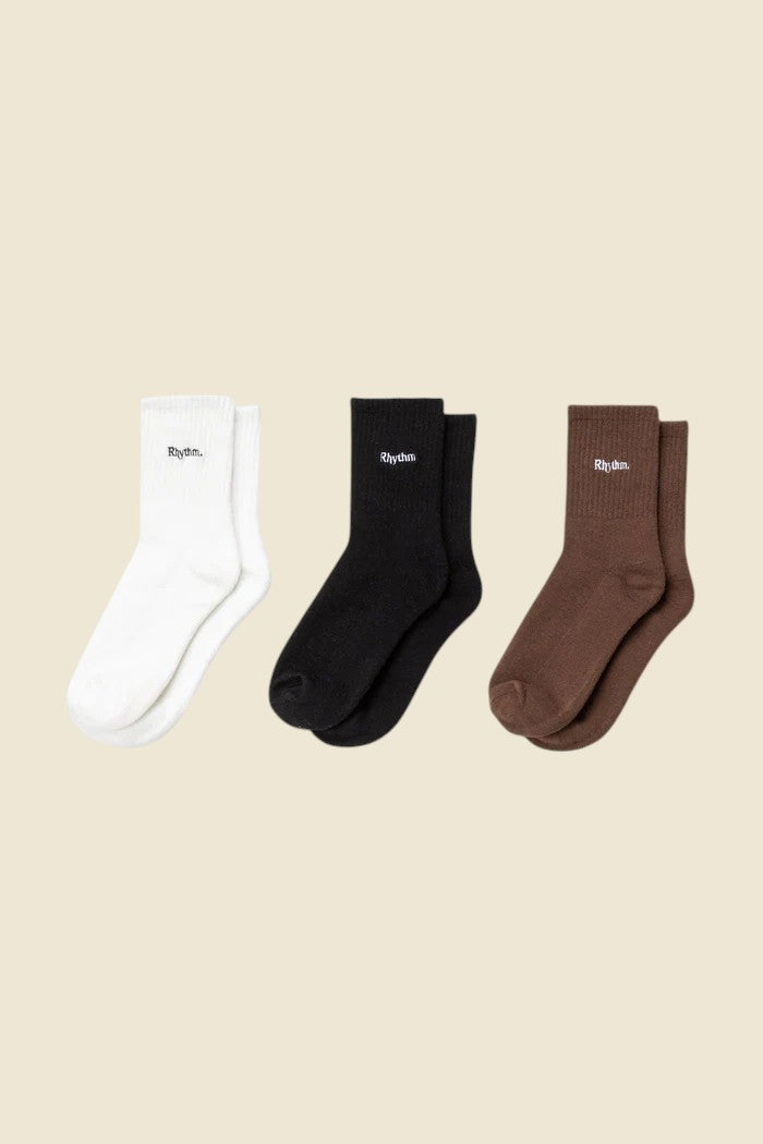 Keel Surf & Supply neutral 3-pack crew socks in white, black, and brown with embroidered logo.