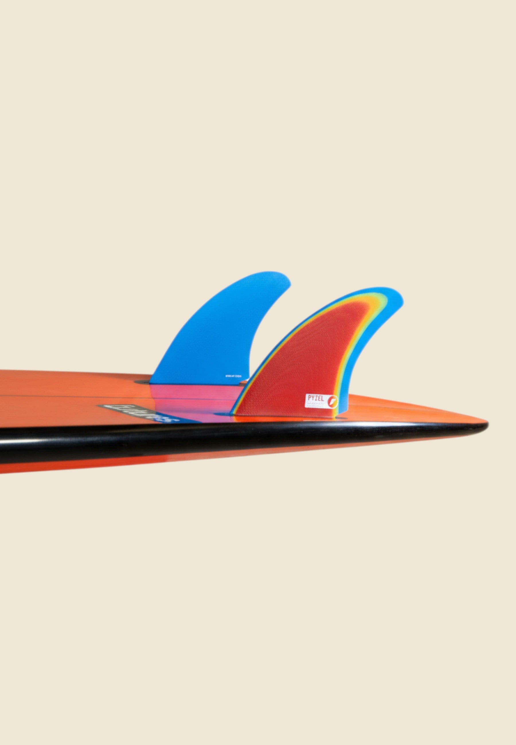 Keel Surf & Supply Pyzel Bobcat Twin fiberglass surfboard fins, red with rainbow foil and blue.