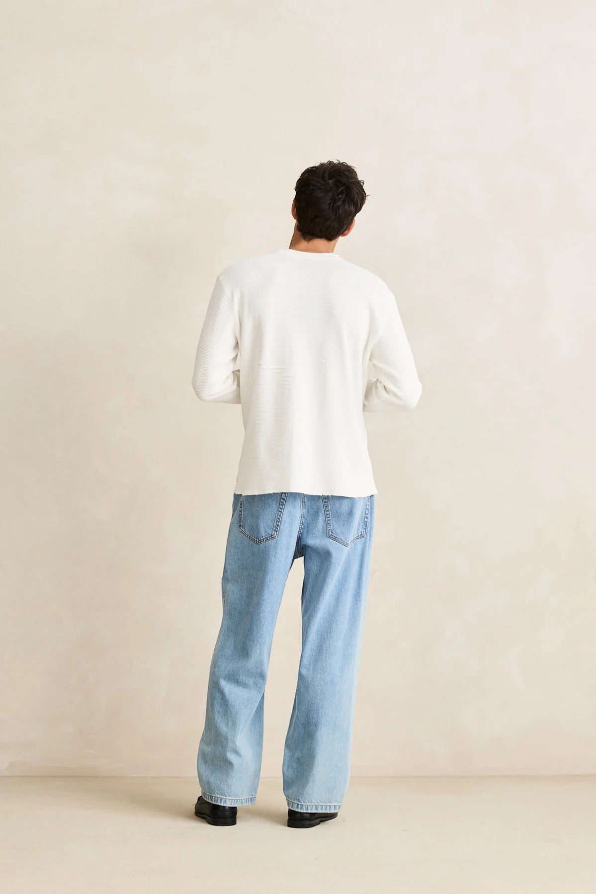 Keel Surf & Supply Rhythm Classic Waffle Knit long-sleeve shirt in vintage white, worn by a man with light wash jeans.