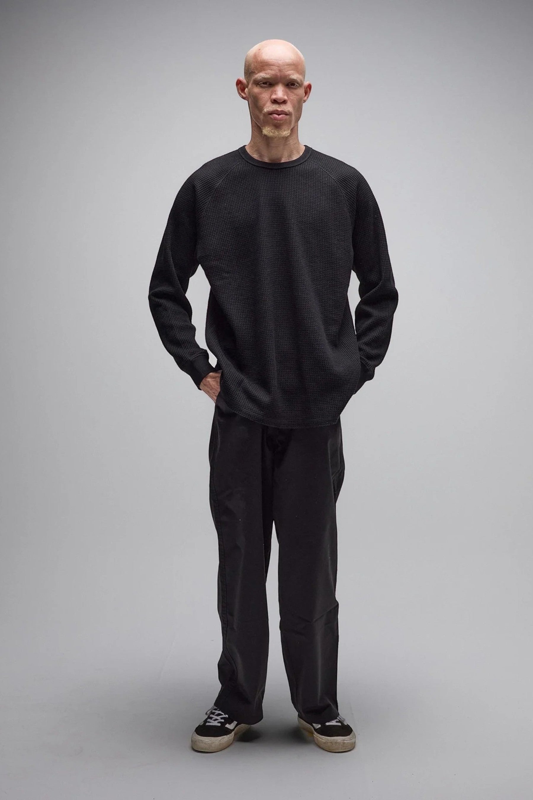 Keel Surf & Supply AG Raglan Waffle black long-sleeve shirt with waffle texture and raglan sleeves on a model.