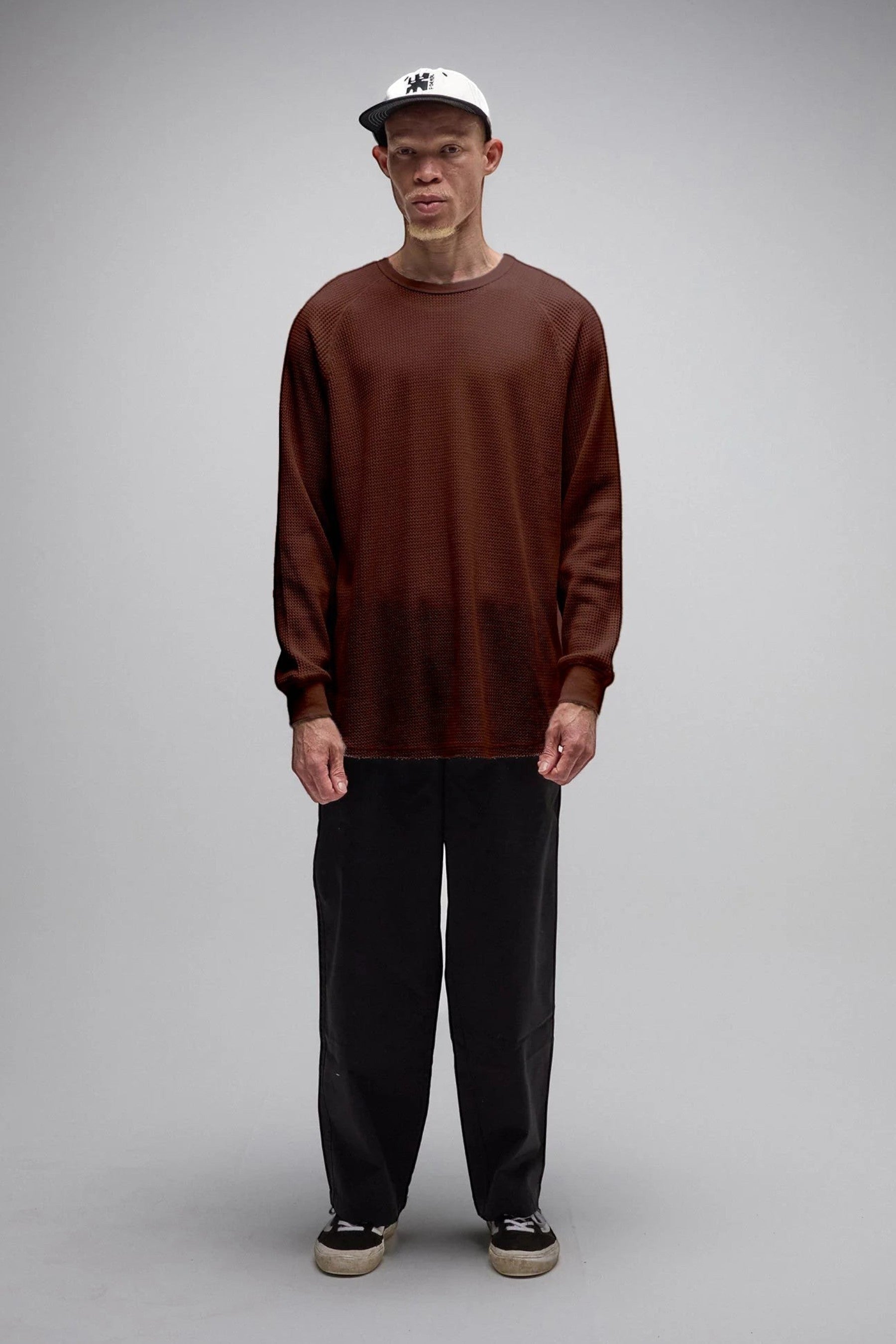 Keel Surf & Supply brown waffle knit long sleeve shirt with raw hem and bound collar, worn by a male model.
