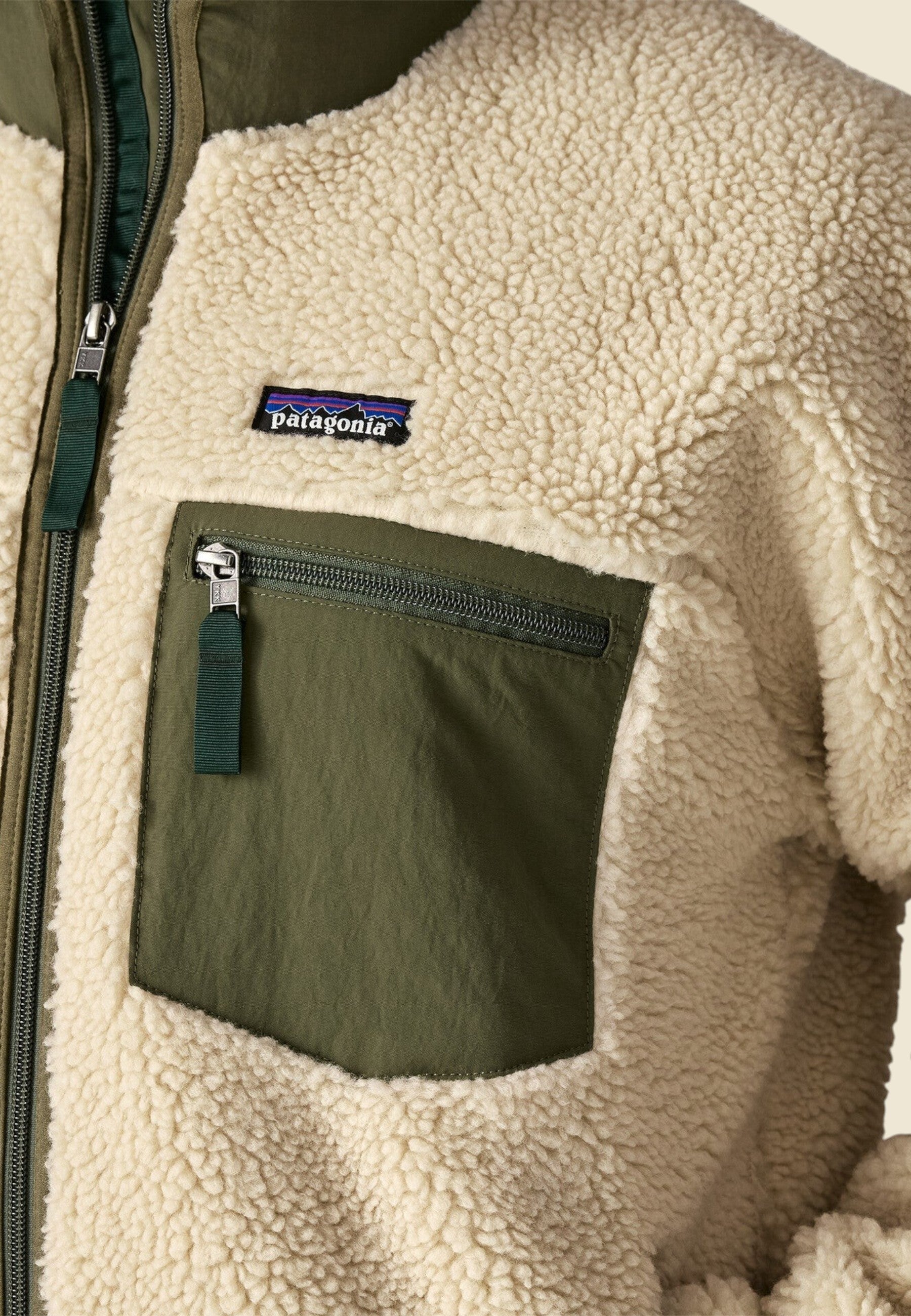 Keel Surf & Supply Men's Classic Retro-X fleece jacket in cream with dark natural and basin green accents. Features zip pockets and Patagonia logo.